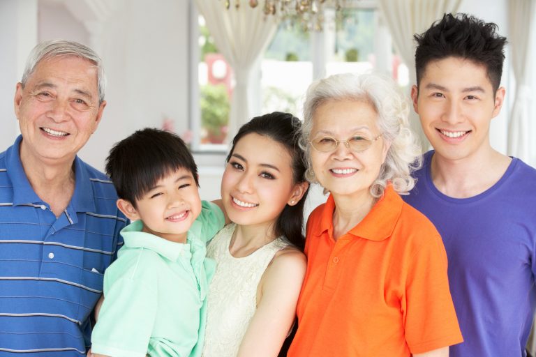 Portrait Of Multi-Generation Chinese Family Relaxing At Home Together